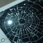 Lucid_Realism_A_closeup_shot_of_a_damaged_tablet_with_a_cracke_2