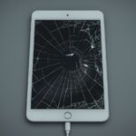 Lucid_Realism_A_worn_and_damaged_iPad_with_a_cracked_screen_di_1